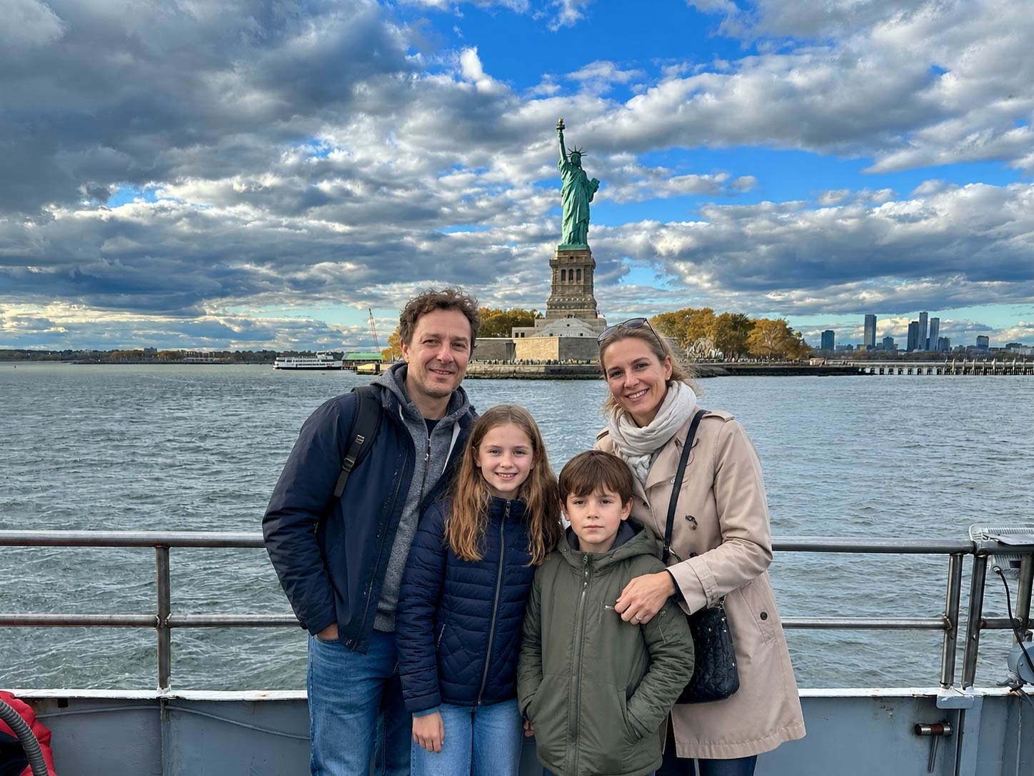 Friendly guests will take photos of your family near the Statue of Liberty.