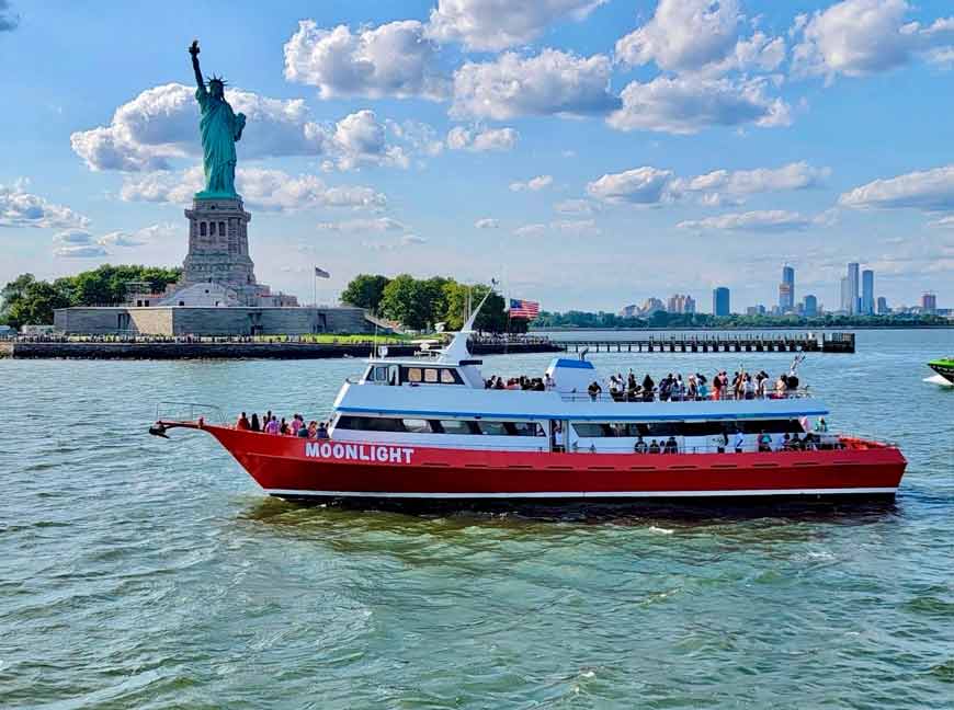Guests enjoying a daytime NYC landmarks cruise in New York Harbor